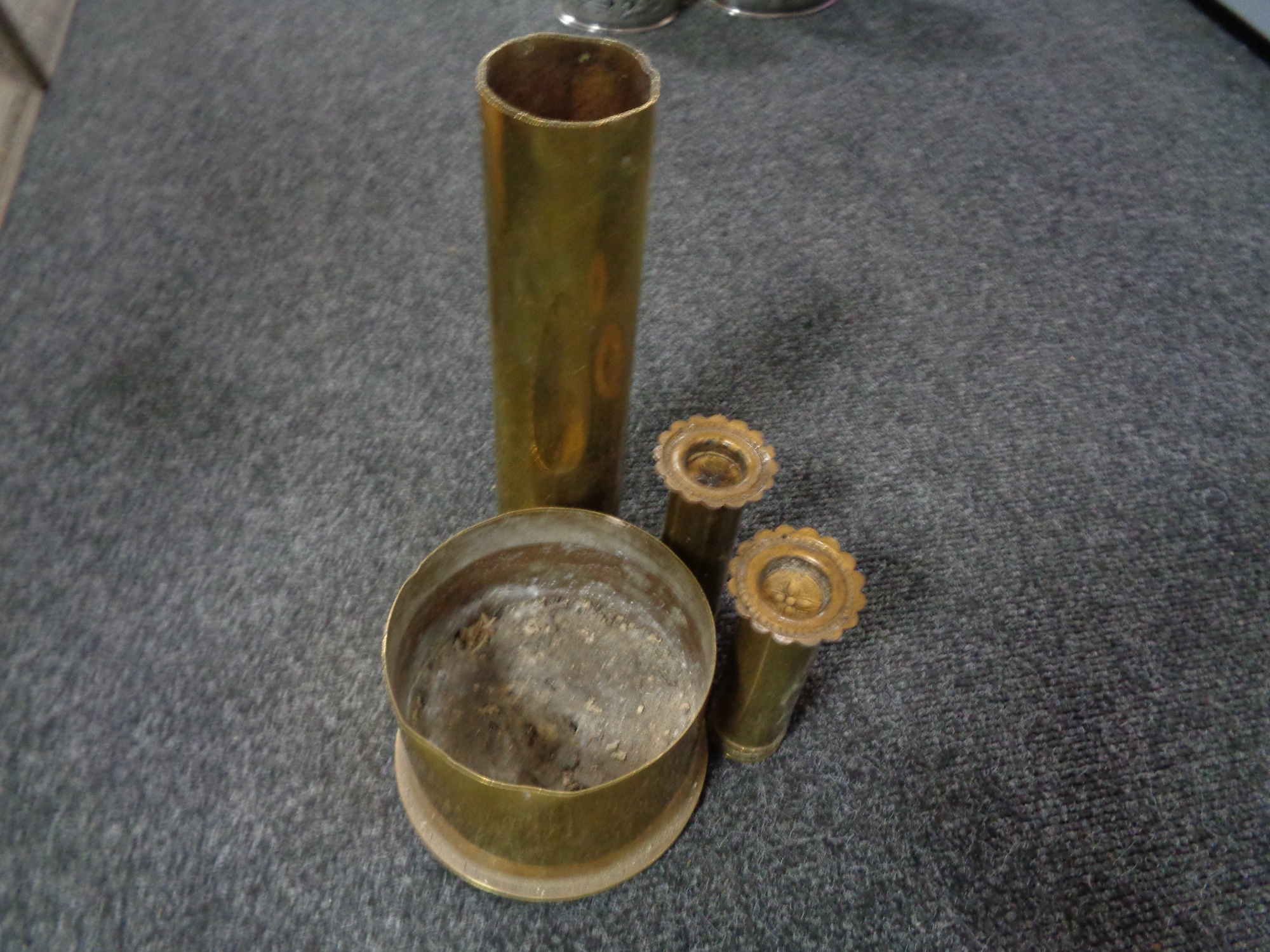 Four brass ammunition shells (Two in the form of candlesticks)