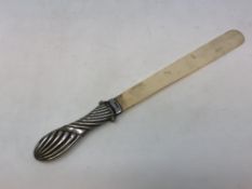 A silver-handled ivory letter opener,