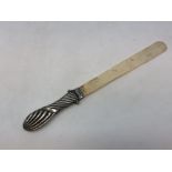 A silver-handled ivory letter opener,