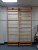 A pair of pine wall mounted clothes racks