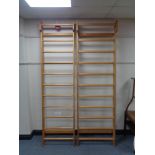 A pair of pine wall mounted clothes racks