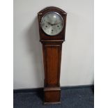 An oak cased granddaughter clock with silvered dial