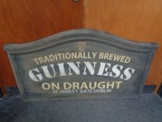 A hand painted chalk board with Guiness advertising