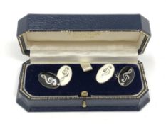 A pair of silver and enamel cuff links depicting musical notes CONDITION REPORT: