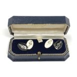 A pair of silver and enamel cuff links depicting musical notes CONDITION REPORT: