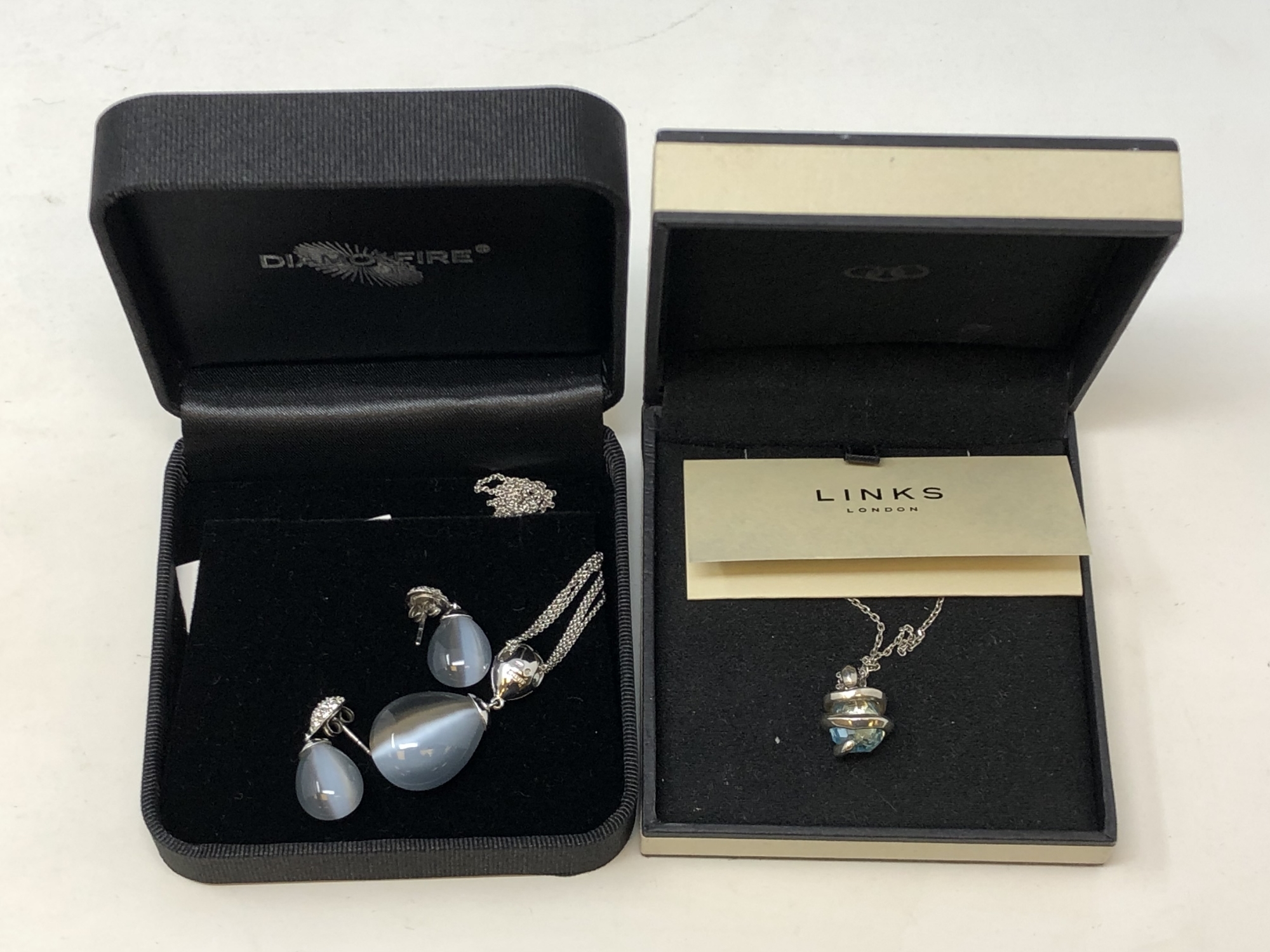 A Diamonfire silver pendant and matching earrings in box,