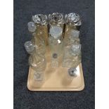 A tray of decanters and cruet bottles, three metal tea caddies.