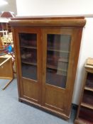 A twentieth century mahogany double door bookcase