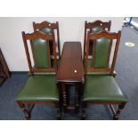 An Old Charm drop leaf table and four chairs upholstered in green leather