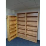Two sets of beech effect bookshelves together with a pine effect shelf