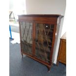 A Victorian mahogany double door bookcase on Queen Anne style legs