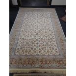 An ivory ground floral carpet 200 cm x 300 cm.