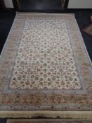 An ivory ground floral carpet 200 cm x 300 cm.