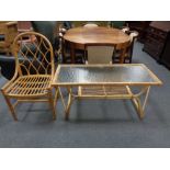 A bamboo and glass topped coffee table together with a chair