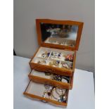 A jewellery chest of costume jewellery including dress rings and brooches etc.