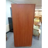 A mid century teak single door wardrobe