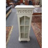A cream painted narrow cabinet