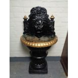 A twentieth century painted cast iron lion mask water feature, height 130 cm.