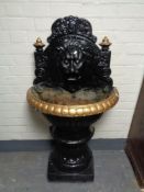 A twentieth century painted cast iron lion mask water feature, height 130 cm.