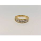 An 18ct gold ring set with 22 princess cut diamonds, total diamond weight approximately 1.