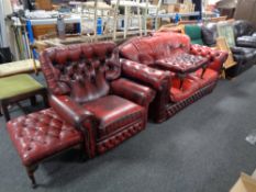 A red buttoned leather two seater settee together with similar armchair and two footstools