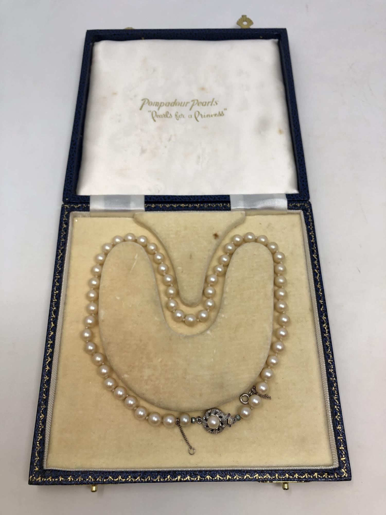 A boxed pearl necklace with clasp stamped 835