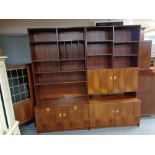 A mid century Danish twin section bookcase fitted with cupboards and drawer beneath