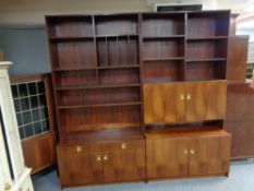 A mid century Danish twin section bookcase fitted with cupboards and drawer beneath
