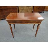 A nineteenth century mahogany turn over topped tea table on reeded legs