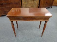 A nineteenth century mahogany turn over topped tea table on reeded legs