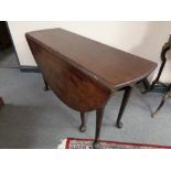 A Victorian mahogany gateleg table on club feet