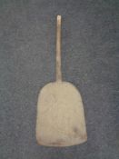 A vintage butter churn paddle