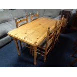 A pine rectangular kitchen table together with a set of four ladder backed chairs