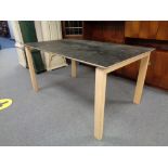 A contemporary dining table on pine legs