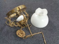 A Continental gilt metal hanging oil lamp with opaque glass reservoir (converted),