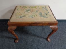 A Victorian mahogany dressing table stool upholstered in a tapestry fabric