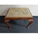 A Victorian mahogany dressing table stool upholstered in a tapestry fabric