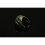A continental yellow gold ring, the textured shank set with a cabochon apple green jade stone,