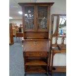 An oak Arts and Crafts bureau bookcase with leaded glass doors