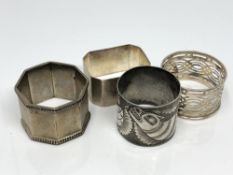 Four silver napkin rings including one Chinese showing a serpent