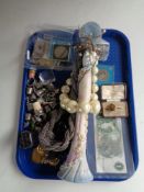 A tray of costume jewellery, Royal Engineers tie pin, metal thimbles, coins, one pound bank note.