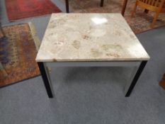 A marble topped coffee table on metal legs