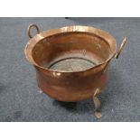 An Art Nouveau copper twin handled planter on raised feet , diameter 41 cm.