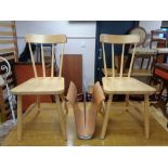 A pair of pine spindle backed dining chairs and contemporary magazine rack