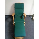 A teak steamer garden chair with adjustable foot rest and cushion