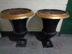 A pair of cast iron painted urn planters, height 97 cm.