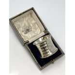 A large boxed silver serviette ring,