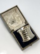 A large boxed silver serviette ring,