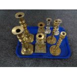 A tray of three pairs of brass candlesticks and further pair of plated candlesticks