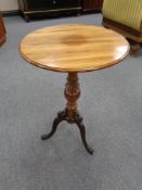 An antique mahogany wine table on cast iron legs